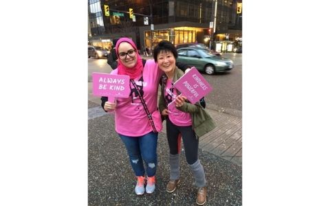 2 women with wearing pink shirts on the street